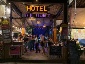 a group of people walking around a food stand at night at Hotel Frida Paradise in Brisas de Zicatela