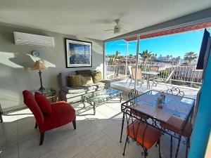 a living room with a couch and a table at Stunning Azul Ocean View Apartment in San Carlos