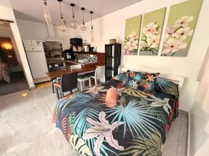 a bedroom with a bed with a colorful blanket at Miki Miki House in Fare