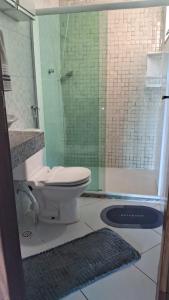 a bathroom with a toilet and a glass shower at Casa da Praia Costazul in Rio das Ostras +35 photos