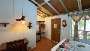 a bedroom with a bed and a ceiling fan at Hotel Frida Paradise in Brisas de Zicatela