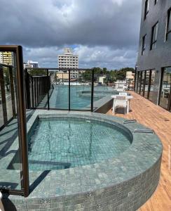a swimming pool on the balcony of a building at Ilusion hotel flat in Natal