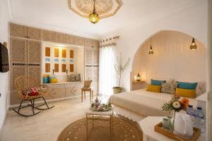 a bedroom with a large bed and a bathroom at DAR COLIBRI - Maison de charme à Kélibia in Kelibia +80 photos