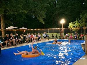 a group of people in a swimming pool at Cabin #1 on Meramec River in Steelville +2 photos