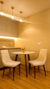 a table and two chairs in a kitchen at Nautilus Apartment in Batumi