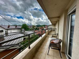 a balcony with a chair and a view at Liberty Apartments in Cetinje