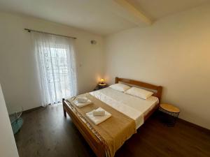 a bedroom with a bed with two towels on it at Liberty Apartments in Cetinje
