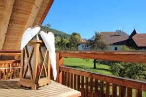 a white umbrella sitting on top of a wooden table at Apartments Im Winkl in Brunico