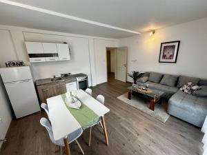 a kitchen and living room with a table and a couch at Liberty Apartments in Cetinje