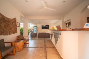 a living room with a bar and a couch at Villa Casalet in Puerto Escondido +17 photos
