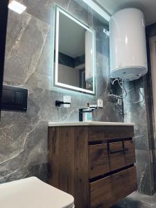 a bathroom with a sink and a mirror at Asteris Apartments in Demir Kapija +83 photos
