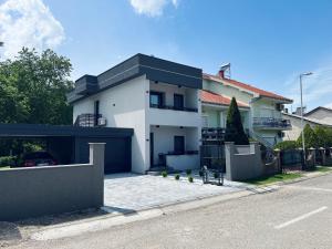 a white house with a black garage at Asteris Apartments in Demir Kapija