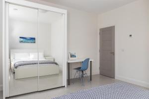 a bedroom with a bed and a desk and a chair at Gorgeous Luxury in Lahinch