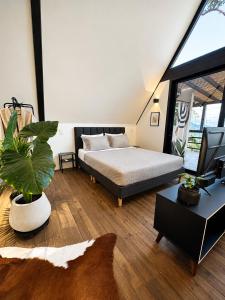 a bedroom with a bed and a table with a plant at Private Luxury A-Frame with Jacuzzi & Mountain View in San Francisco