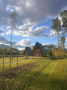 a house in the middle of a field at RIVERSTONE Drašković camp and bungalows in Nikšić