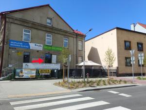 a building on the corner of a street at Chopina Place in Oświęcim