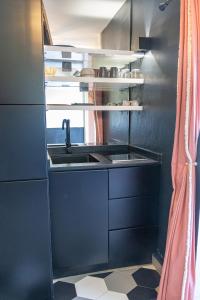 a kitchen with a sink and a counter at Village Soleil in Le Gosier