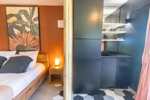 a small bedroom with a bed and a shelf at Village Soleil in Le Gosier +20 photos