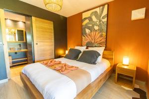 a bedroom with a large bed with two pillows on it at Village Soleil in Le Gosier