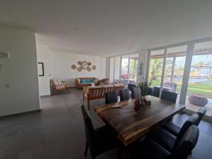a living room with a wooden table and chairs at Venice House, Costa del Sol in San Luis La Herradura