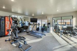a gym with several treadmills and machines in a room at Best Western Foothills Inn in Mountain Home