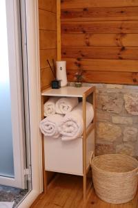 a room with a shelf with towels and a basket at Airport Comfort Nest in Kamëz +7 photos