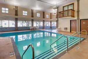 a large swimming pool with blue water in a building at Econo Lodge Inn & Suites Oconto in Oconto