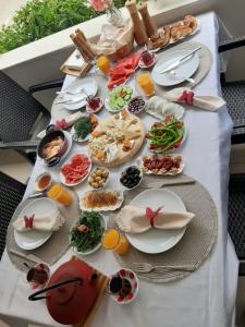 a table with plates of food on top of it at Sevo Hotel in Ayvalık +16 photos
