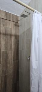a shower with a white shower curtain in a bathroom at Agena Cabrero in Cartagena de Indias