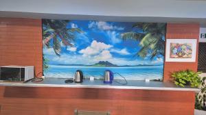 a mural of a beach scene on a wall at Hotel Kolman in Capão da Canoa
