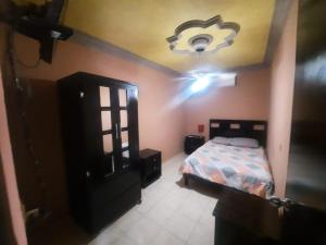 a bedroom with a bed and a ceiling at Garcias Suites Cuauhtémoc in Linares