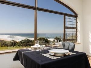 a dining table with a black table cloth and glasses at La Vue in Port Shepstone