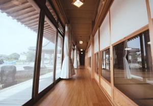 a corridor of a building with windows and a wedding dress at 鈴籠城 鈴の間 - ダブルベッド2台 - 最大4名 in Nagahama