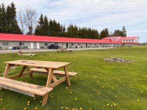 a picnic table in a field in front of a building at Wiarton Willys Inn in Wiarton