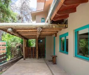 a porch of a house with a wooden entrance at Carumel in Villa Ciudad Parque