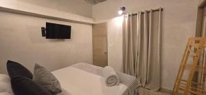 a living room with a white couch and a television on the wall at Agena Cabrero in Cartagena de Indias