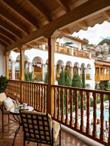 a balcony with a table and chairs and a building at Palacio Nazarenas, A Belmond Hotel, Cusco in Cusco