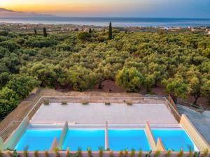 an aerial view of a swimming pool in a villa at Helena's Aether Suites - Seaview & Heated Infinity Pool in Tragaki