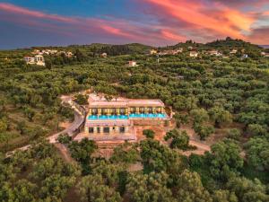 an aerial view of a house on a hill at Helena's Aether Suites - Seaview & Heated Infinity Pool in Tragaki