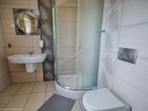 a bathroom with a shower and a toilet and a sink at Agroturystyka U Marty in Trzcinica