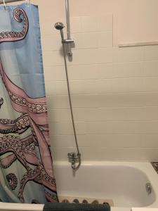 a bathroom with a bath tub and a shower curtain at Casa cesari in Ajaccio +32 photos