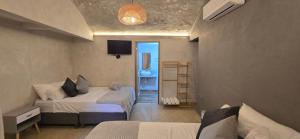 a hotel room with two beds and a bathroom at Agena Cabrero in Cartagena de Indias