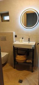 a bathroom with a sink and a mirror at Ellotis Stone Retreat in Áyioi Dhéka