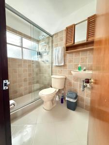 a bathroom with a toilet and a sink and a shower at Roomies House By Rincon in Medellín +61 photos