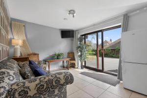 a living room with a couch and a sliding glass door at 2 Bed in Alkham oc-p34785 in Swingfield