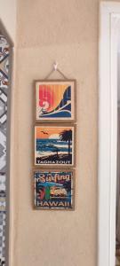 three pictures are hanging on a wall at Petit villa centre harhoura Près de la plage in Temara +6 photos