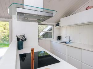 a kitchen with white cabinets and a sink at 5 star holiday home in Jerup in Jerup +31 photos