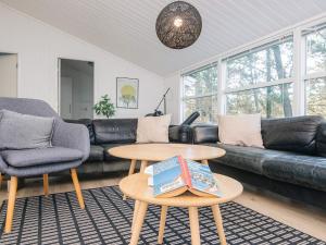 a living room with a couch and a table at 5 star holiday home in Jerup in Jerup