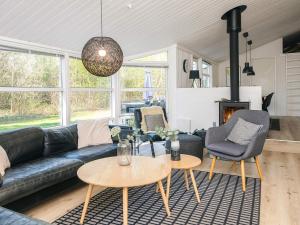 a living room with a couch and chairs and a table at 5 star holiday home in Jerup in Jerup