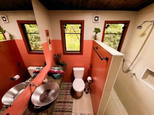 a small bathroom with a toilet and a sink at Sítio Passarim in São Francisco Xavier +136 photos